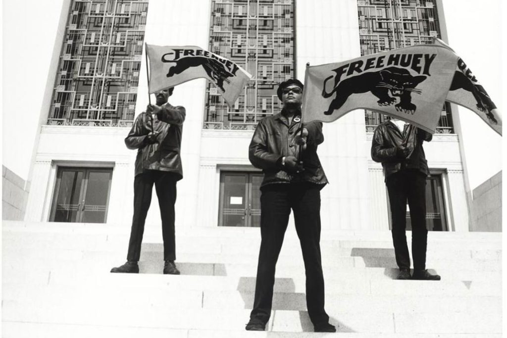 3 Black Panther men standing on the steps of a courthouse