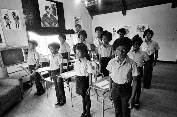 Children in a classroom standing up